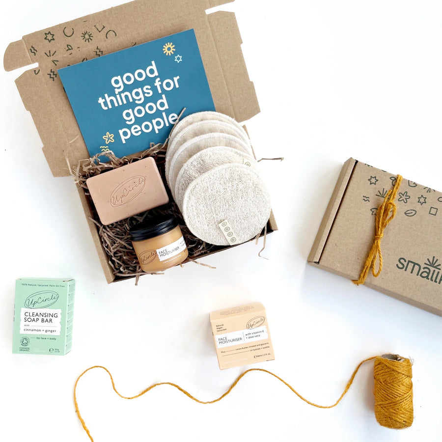 natural skincare gift set with organic cotton facial pads, a solid facial cleansing bar and a glass jar of face moisturiser all by UpCircle Beauty. The products come in a hand stamped kraft gift box with a card that reads 'good things for good people' 