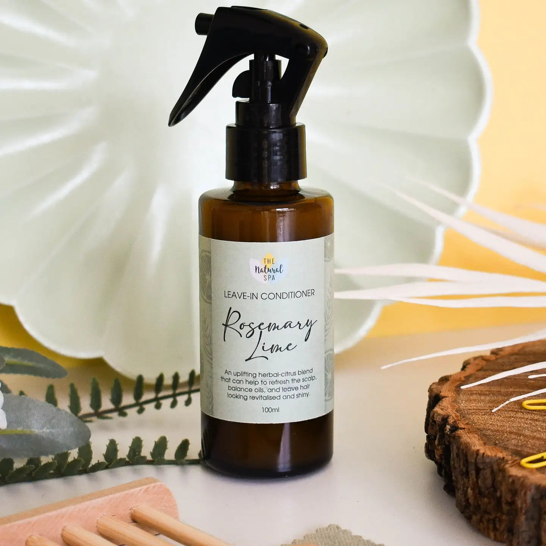 glass spray bottle of rosemary lime leave in conditioner made by The natural Spa 