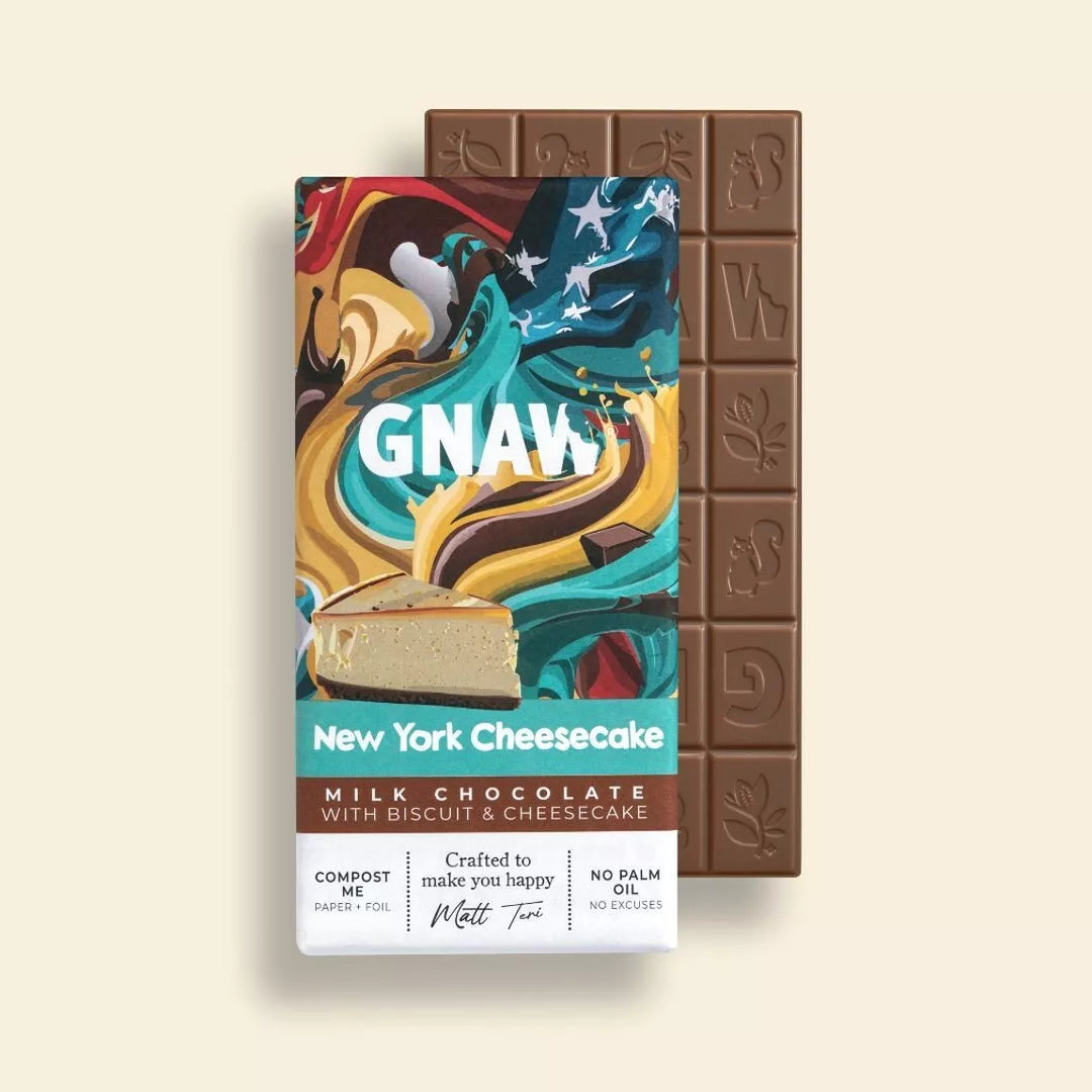 Chocolate bar and packaging of New York Cheesecake flavor with 'GNAW' branding on a beige background