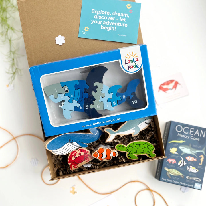 ocean themed kids gift box with shark wooden puzzle, wooden ocean figures and an ocean life memory game