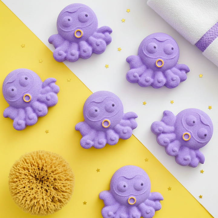 Purple octopus-shaped bath bombs on a yellow and white background