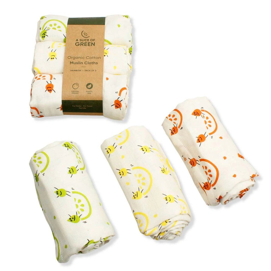 pack of three organic cotton muslin clothes with green, yellow and orange character print