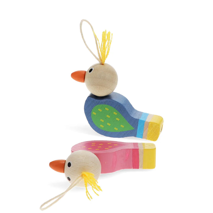 Two colourful wooden bird whistles in pink and blue on a white background