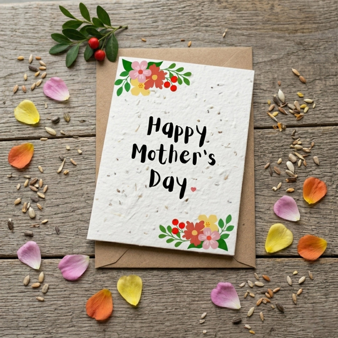 Mother's Day card with floral design and 'Happy Mother's Day' text on a wooden surface with petals and seeds.