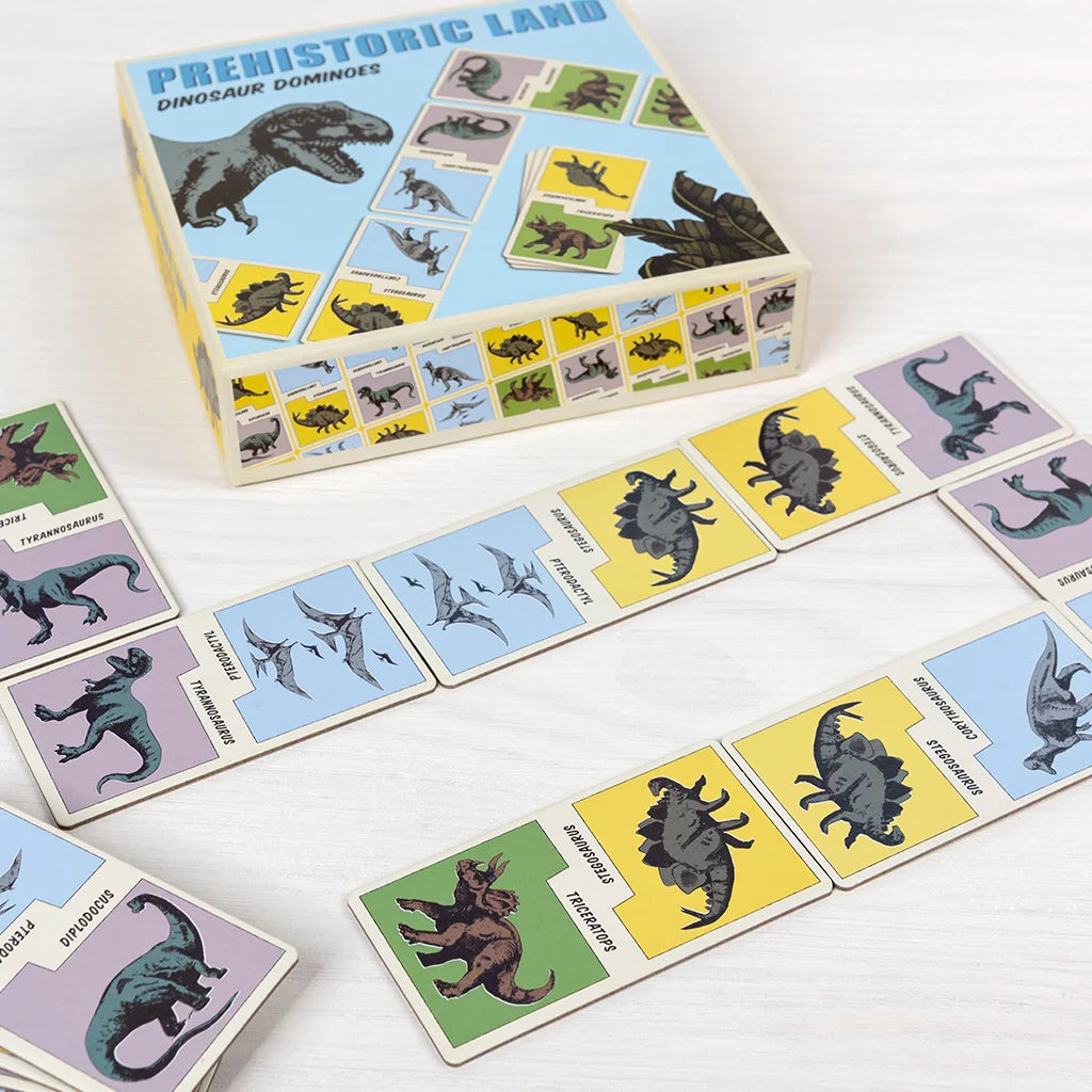 Prehistoric land dinosaur dominoes set with cards and box on a white background