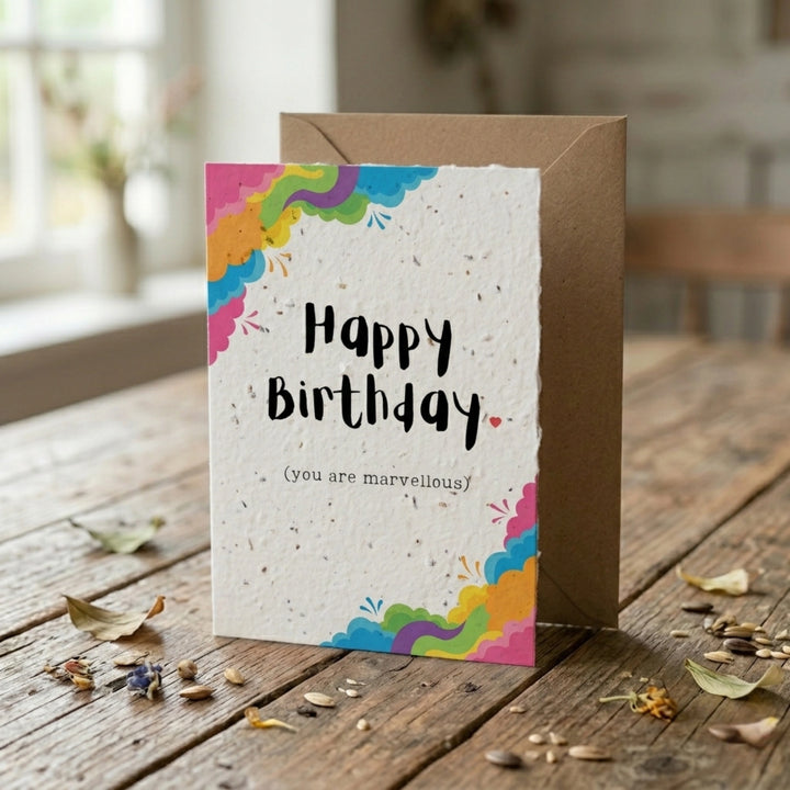 happy birthday plantable card with swirly rainbow design and brown kraft envelope