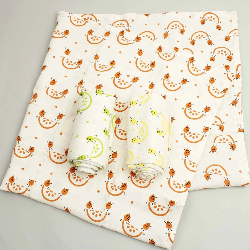 pack of three organic cotton muslin clothes with green, yellow and orange character print