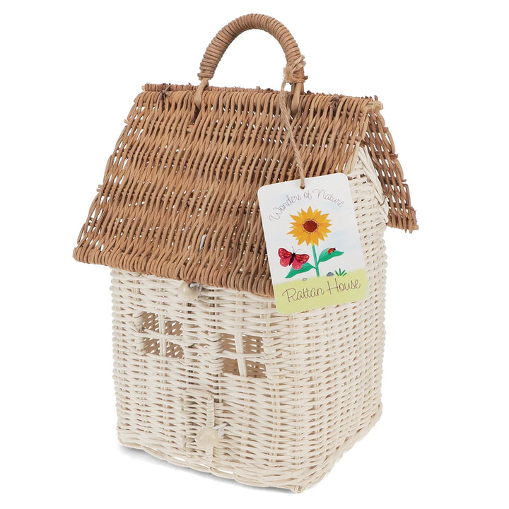 A house-shaped woven wicker basket with a brown wicker roof and handle, a cream-coloured body, and a hanging tag that reads &