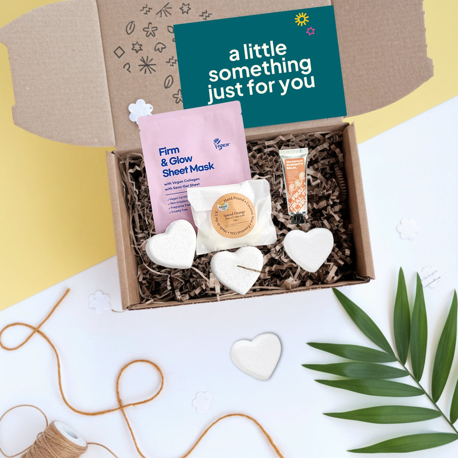 Gift box with skincare products, bath bombs and wax melts on a white background