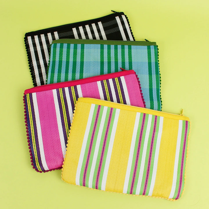 four Respiin Recycled Woven Pom Pom Pouch in blue/green, yellow, pink and black/white checked designs with a  pom pom trim