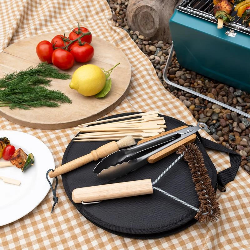 image of the rex London Spirit of Adventure BBQ Tool Set with a portable barbecue and food on a picnic blanket

