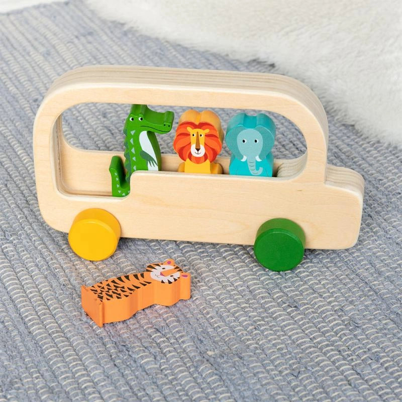 wooden push along bus with four animal characters - tiger, crocodile, lion and elephant. Three of the characters are inside the bus and the tiger is lying on a grey rug. For kids aged 12 months and over. 