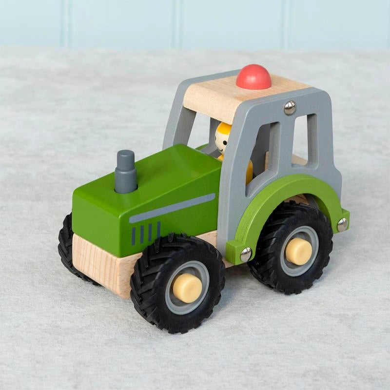 Green Wooden Tractor Push Along Vehicle with a wooden farmer and rubber wheels. Suitable from 12 months and over 