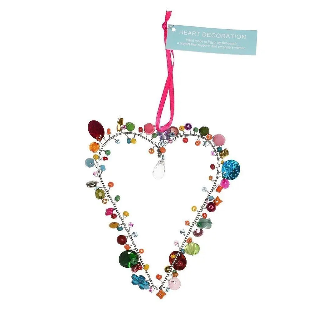 Heart-shaped decoration with colourful beads and a pink ribbon on a white background