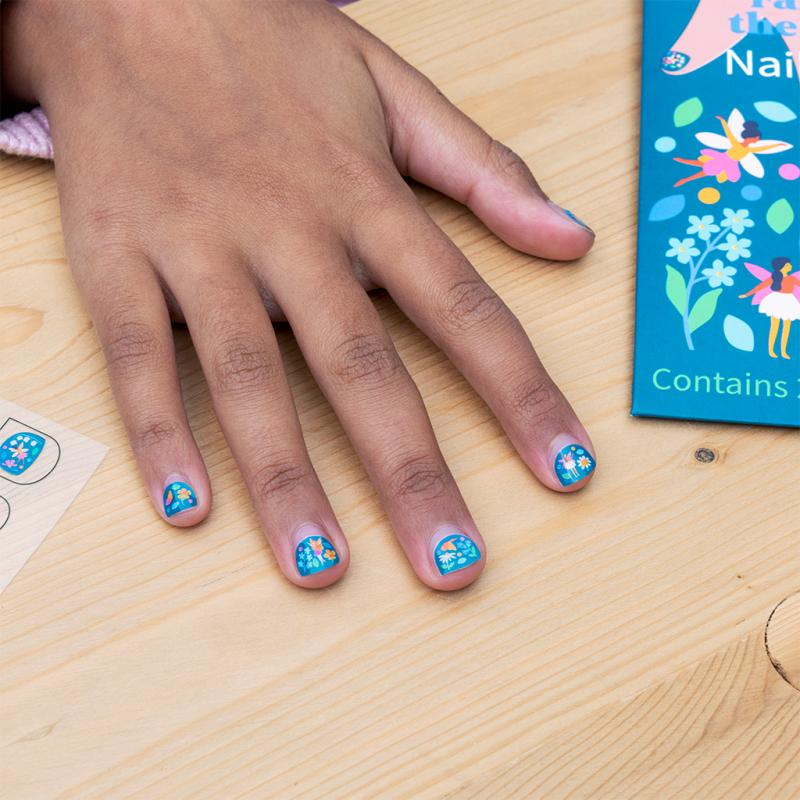 Girls hand with Rex London Children's Temporary Nail Stickers decorating her finger nails. Fir kids age 3 and over 