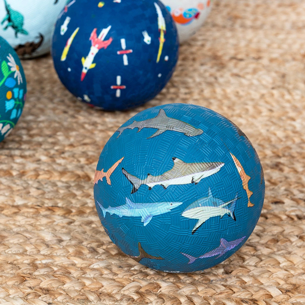 dark blue kids rubber play Ball with shark design ion an indoor carpet. For indoor and  outdoor play. 