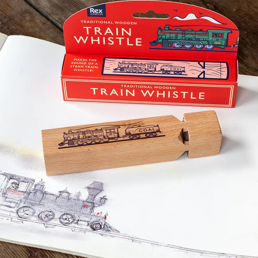classic wooden train whistle for children age 3+. The whistle is printed with a steam train design and lies next to a red train themed gift box.