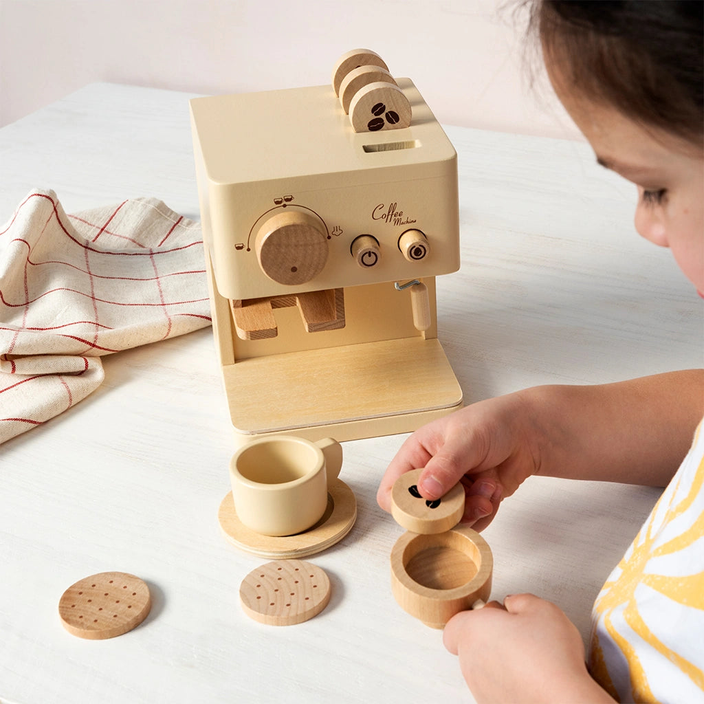 child playing with Rex London Wooden Toy Coffee Machine with cup and saucer, wooden biscuits and coffee pods. for age 3+