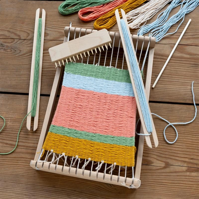 flatlay images of Rex London Children's Wooden Weaving Loom The kit includes a wooden loom with accessories and 5 skeins of yarn in neutral colours. For children aged 6 and over. 