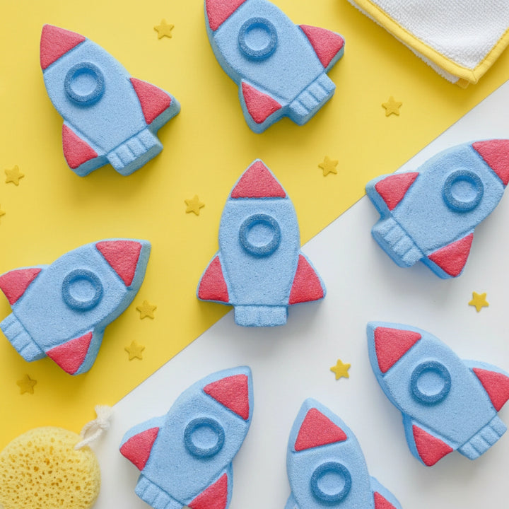 Rocket-shaped bath bombs on a yellow and white background with star decorations