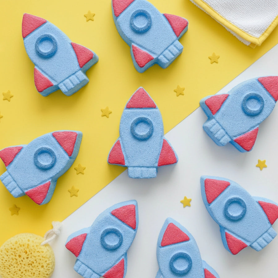 Rocket-shaped bath bombs on a yellow and white background with star decorations