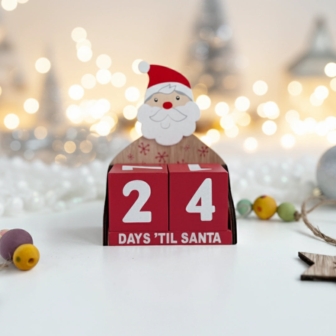 Wooden Santa Claus advent calendar with '24 Days 'Til Santa' text against a blurred festive background.