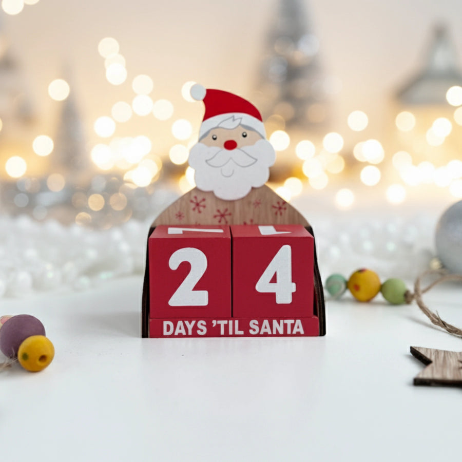 Wooden Santa Claus advent calendar with '24 Days 'Til Santa' text against a blurred festive background.