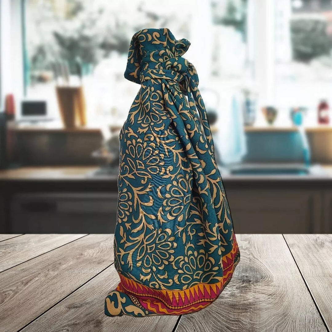 Decorative fabric gift bag with intricate patterns on a wooden surface