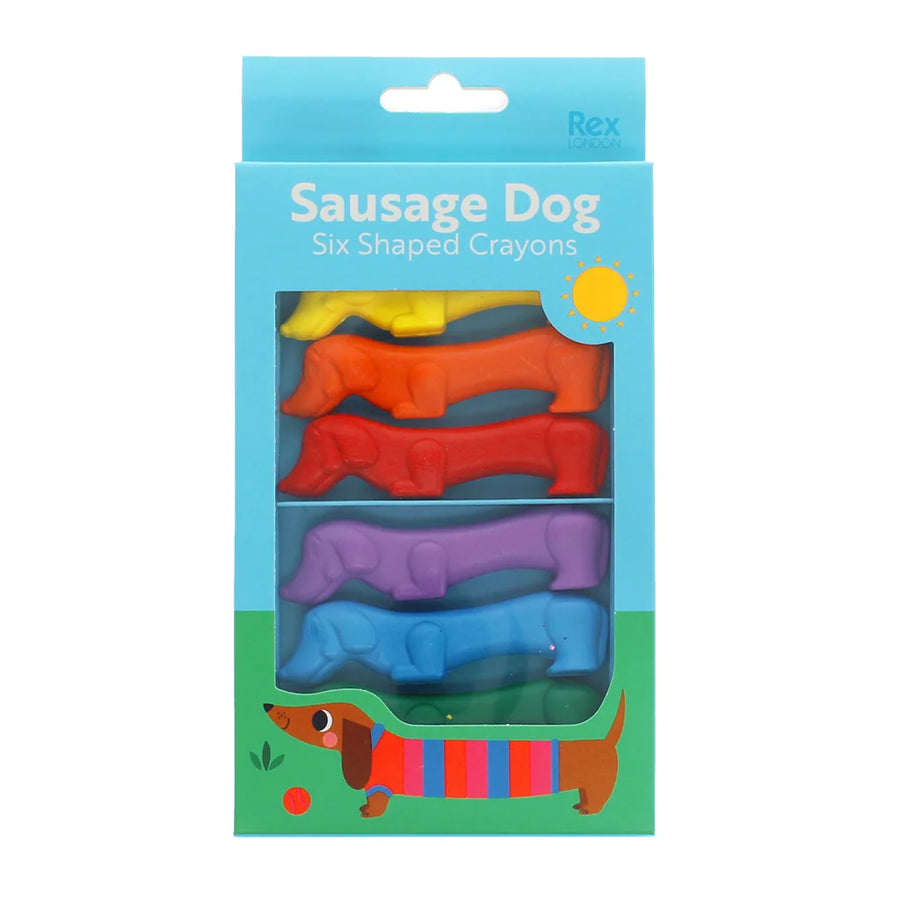 Packaging of six shaped crayons designed like sausage dogs on a blue background.