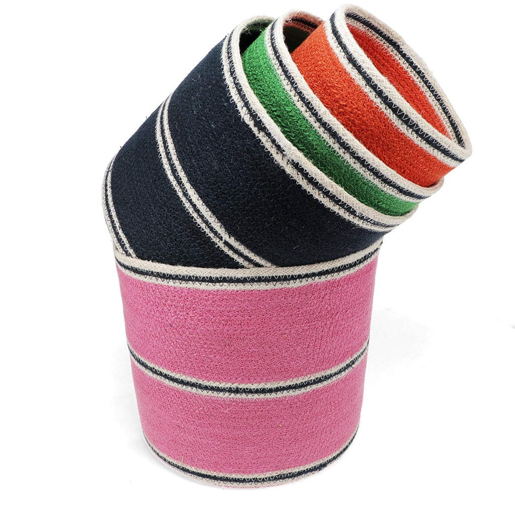 Stack of colourful striped woven baskets in pink, black, green and orange on a white background