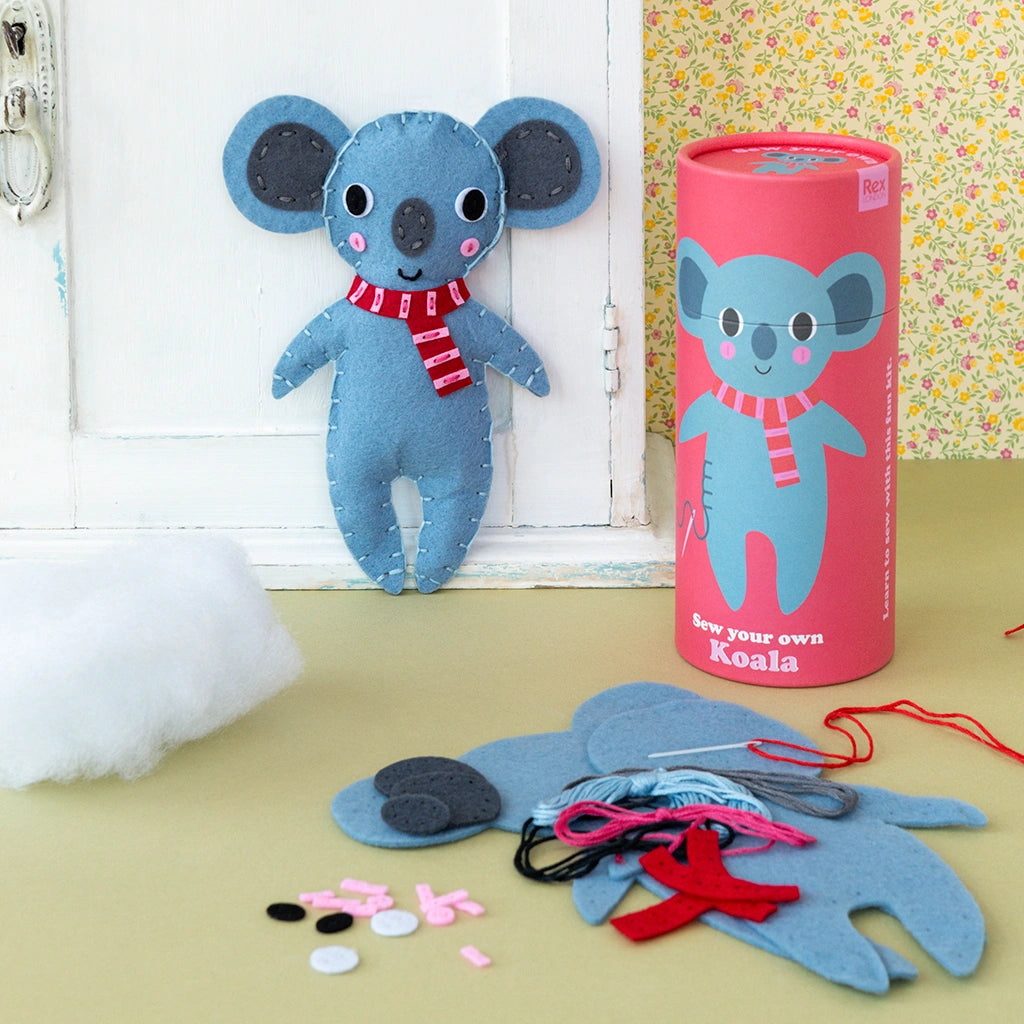 sew your own koala kids craft kit by rex London. Finished koala with red gift tube and felt pieces and threads. 