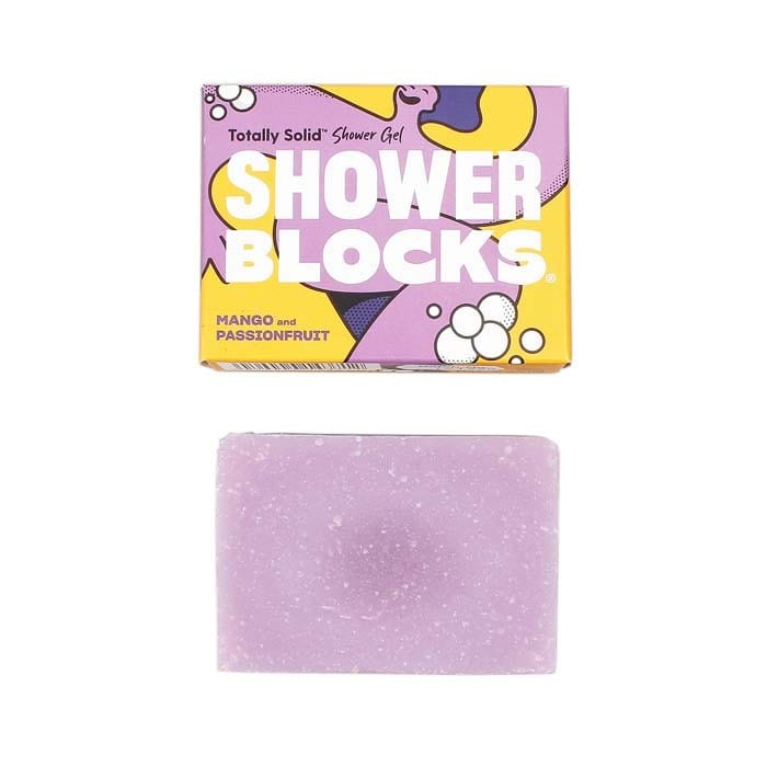 A shower block bar with a purple hue and a packaging box with 'Shower Blocks' text and a colorful design.
