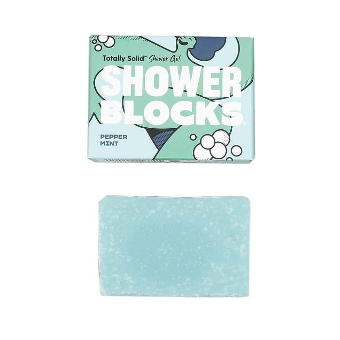 A solid blue shower gel bar labeled 'Shower Blocks' with peppermint fragrance, displayed next to its recycled cardboard packaging that reads 'Peppermint'.
