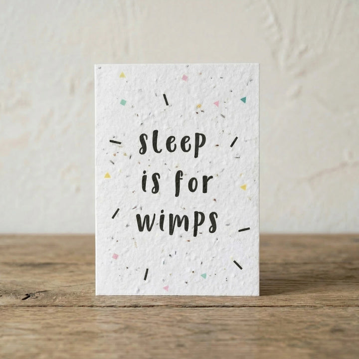 Card with 'sleep is for wimps' text on a textured white background