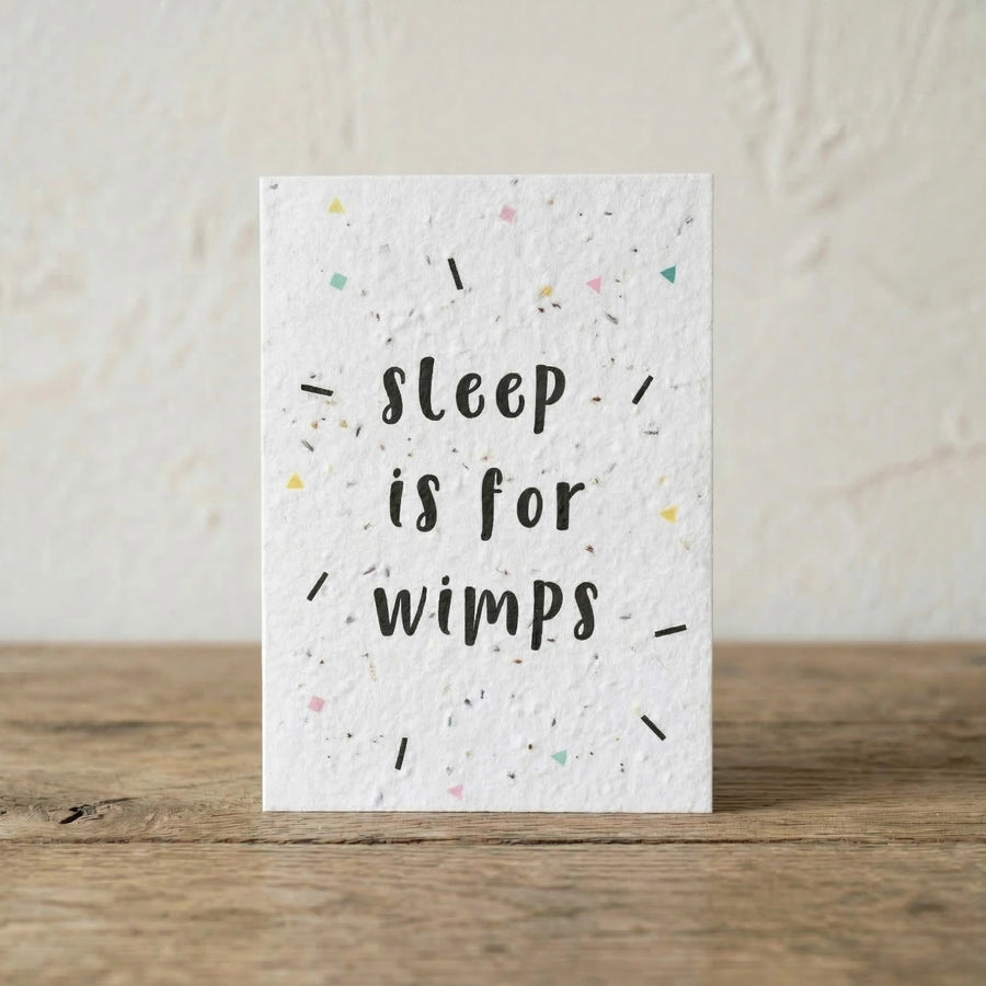 Card with 'sleep is for wimps' text on a textured white background