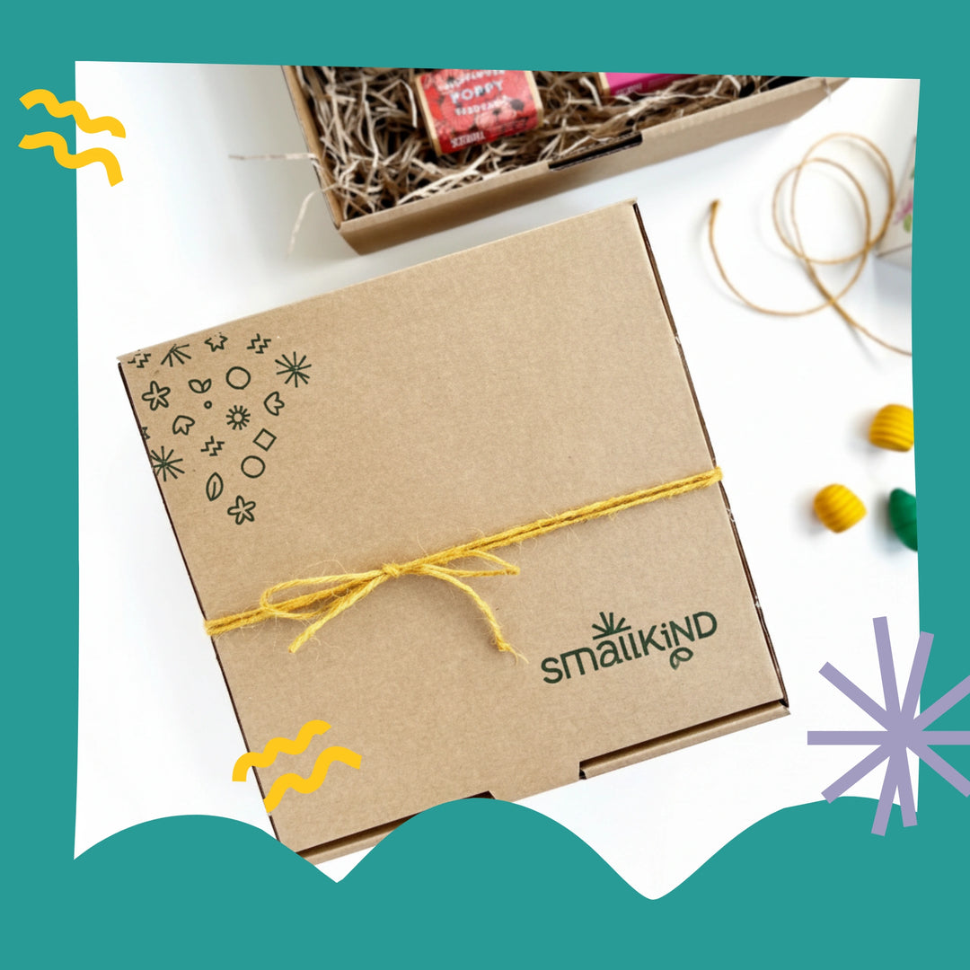 Kraft gift box with yellow twine featuring the 'Smallkind' brand, on a white background.
