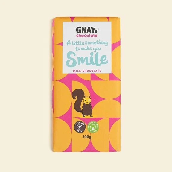 milk chocolate bar in ornage and pink geometric packaging with a cute illustrated squirrel and a message which reads ' a little something to make you smile'