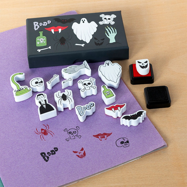Set of Halloween-themed stamps on a purple surface with a black box labeled 'Boo'.