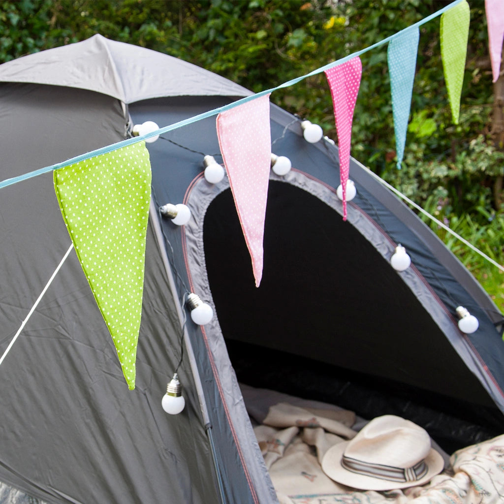 colourful polka dot fabric bunting with a teal green trim strung over a tent. Washable and suitable for outdoor use. 