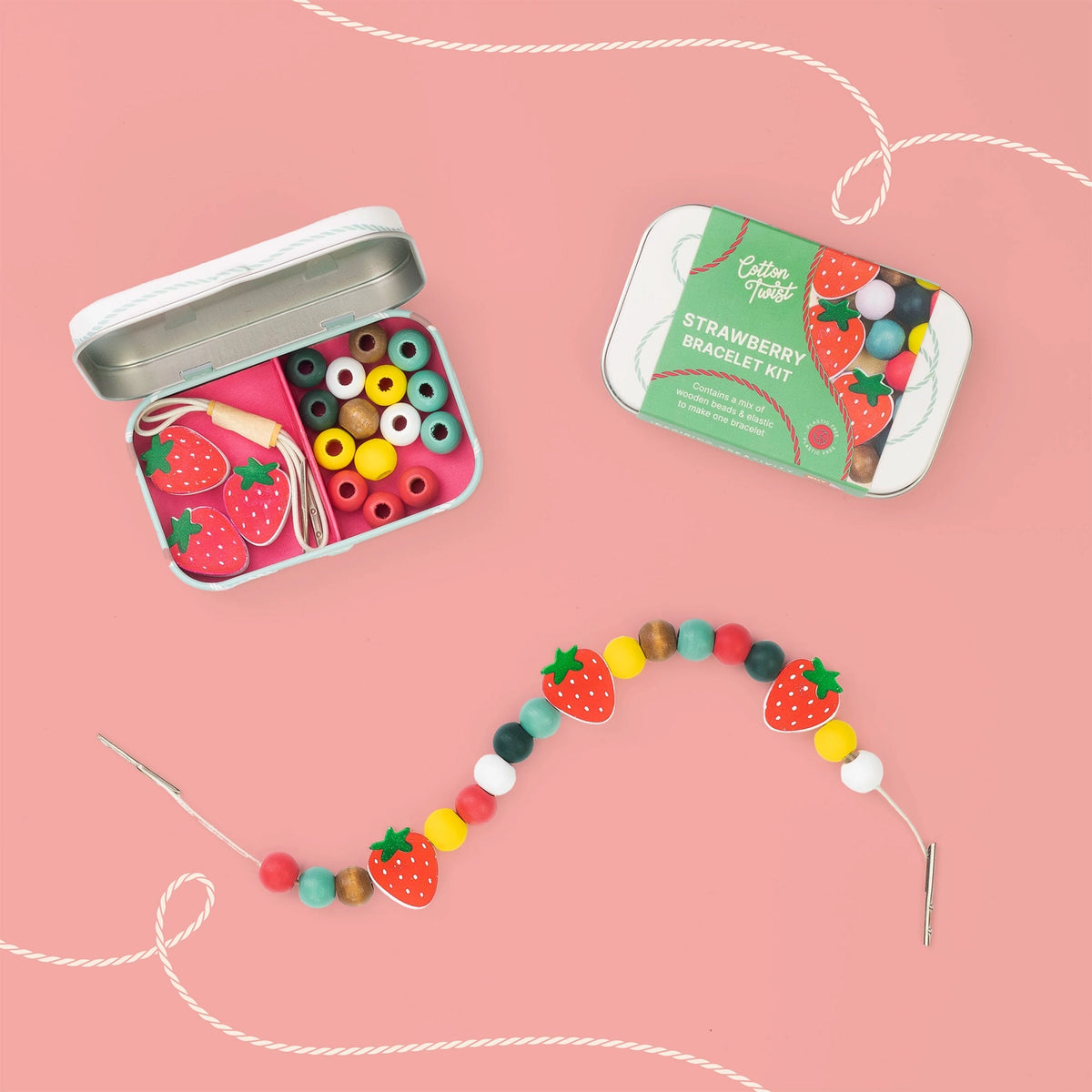 strawberry shaped beads with colourful spacer beads in a gift tin on pink background
