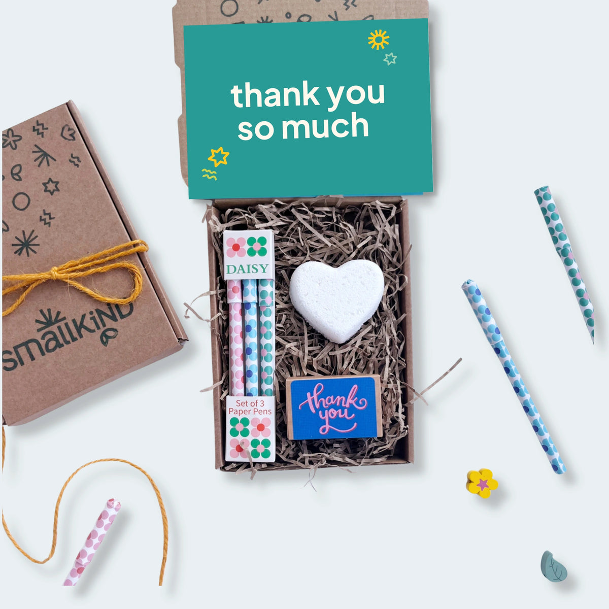 Gift set with stationery items and a 'thank you so much' card on a white background