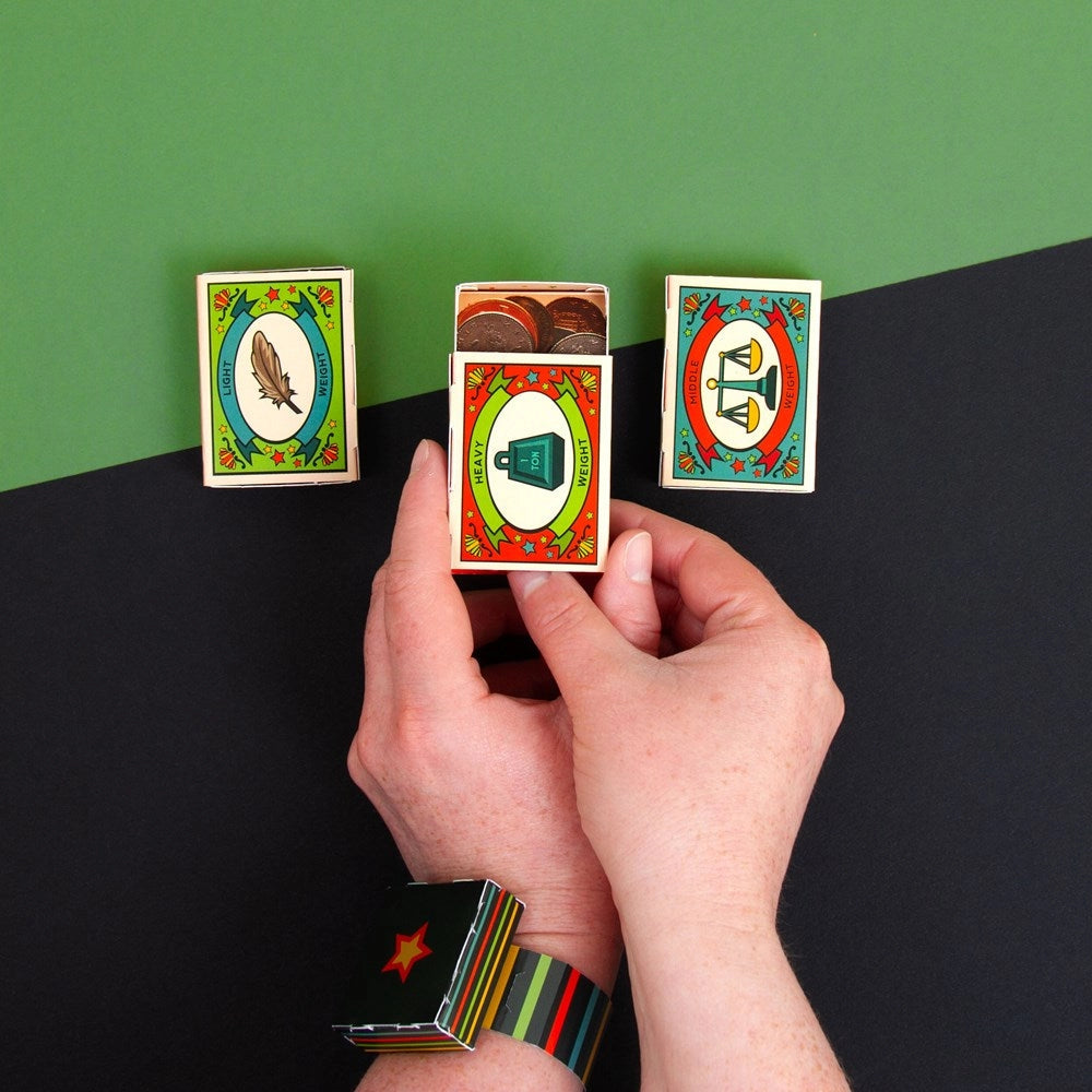 Hands holding a deck of cards with colorful designs on a black and green background