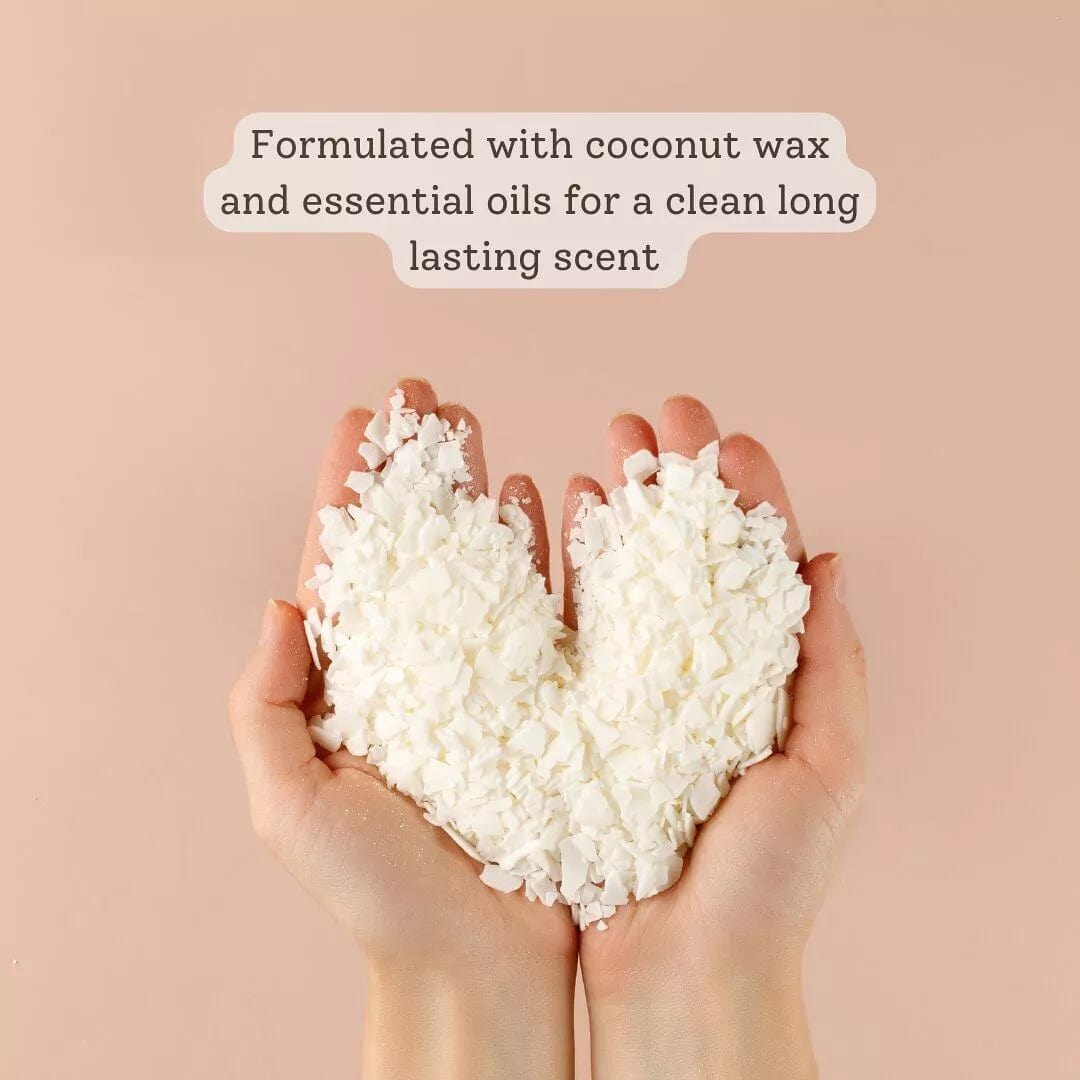 hands holding shredded coconut wax arranged into a heart shape