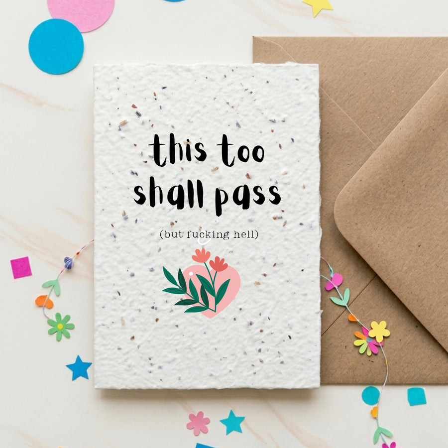 Card with 'this too shall pass' text and envelope on a colorful background