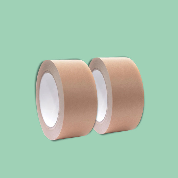 Two rolls of brown tape on a light green background