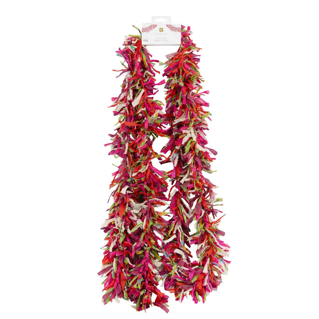 Colourful upcycled fabric tinsel Christmas decoration on a white background