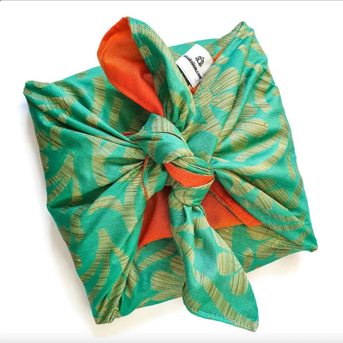 Green patterned fabric gift wrap with a red interior on a white background