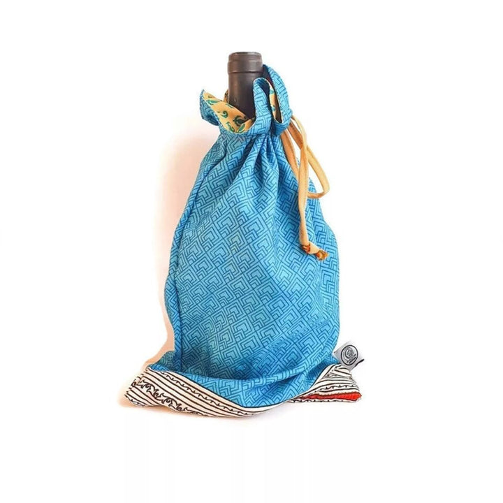 Blue drawstring gift bag with a pattern holding a bottle on a white background