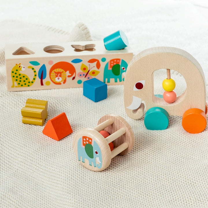 Assorted wooden toys for toddlers from the Wild Wonders range on a textured surface