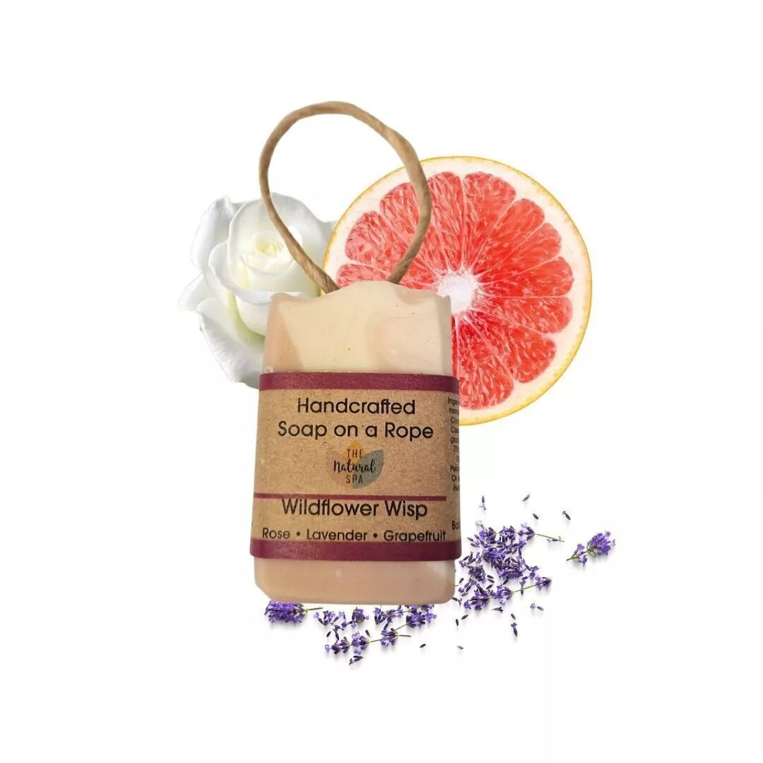 Handcrafted soap on a rope with grapefruit and lavender elements on a white background